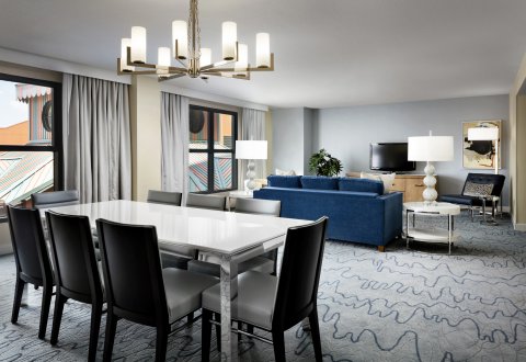 Swan Grand Suite Dining Room with Tables, Couch, Chairs and Large TV