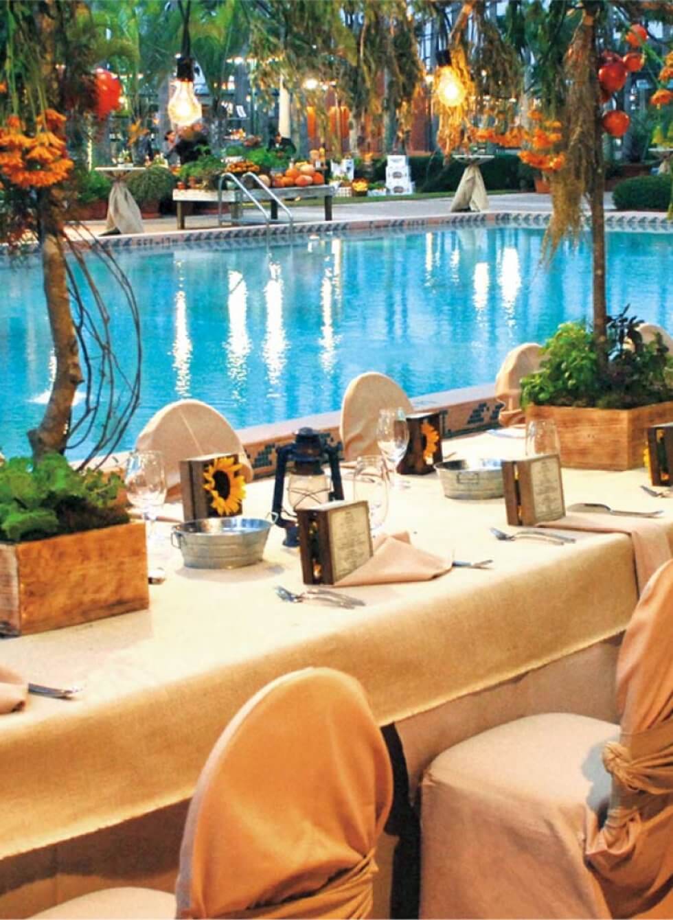 Tables and Chairs Set for a Dinner Event by the Pool