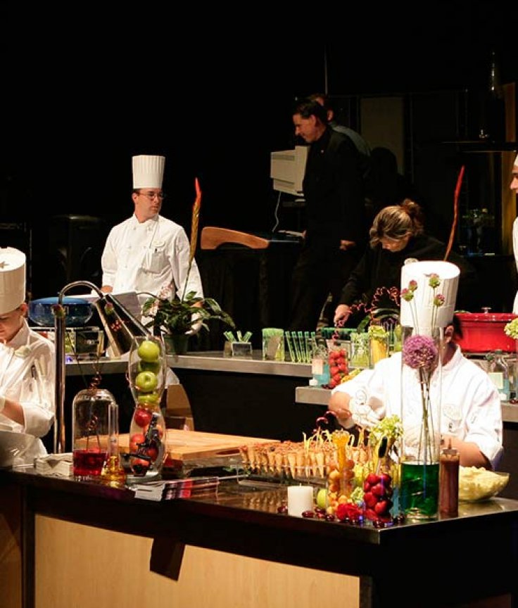 Nine Chefs Preparing Food at an Event
