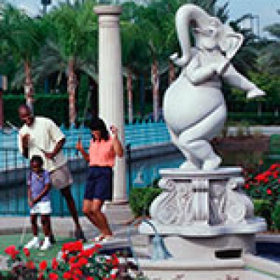 Family Posing Next to a Sculpture at Walt Disney World World Championship Golf