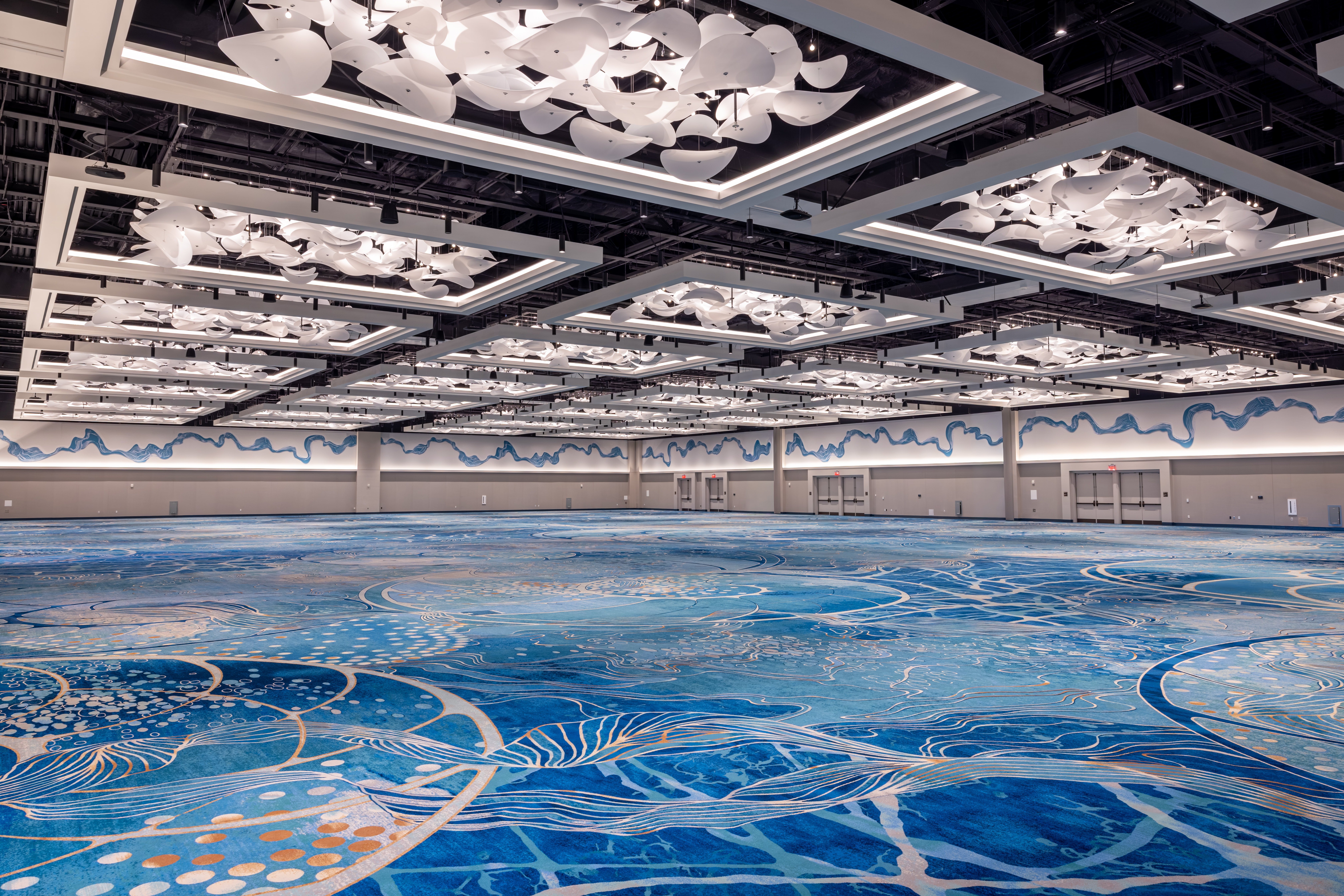 A view of the Peninsula Ballroom located at the Walt Disney Dolphin with blue carpet and lots of overhead lighting.