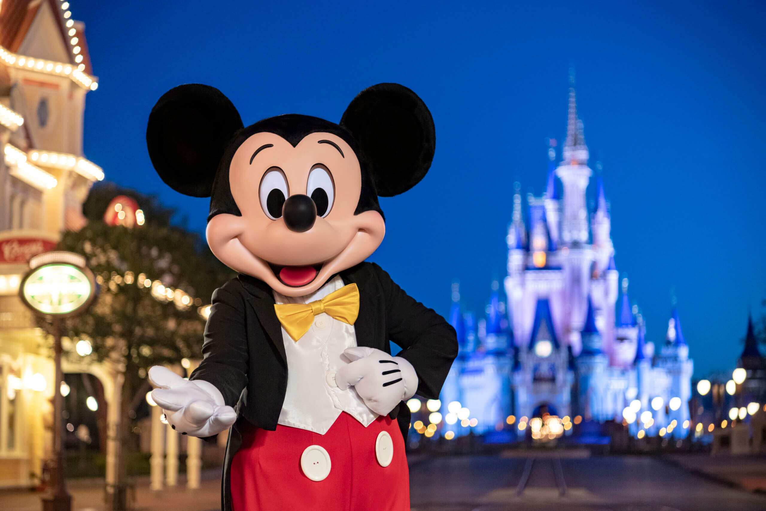Mickey Mouse in from of Cinderella's Castle as dusk.
