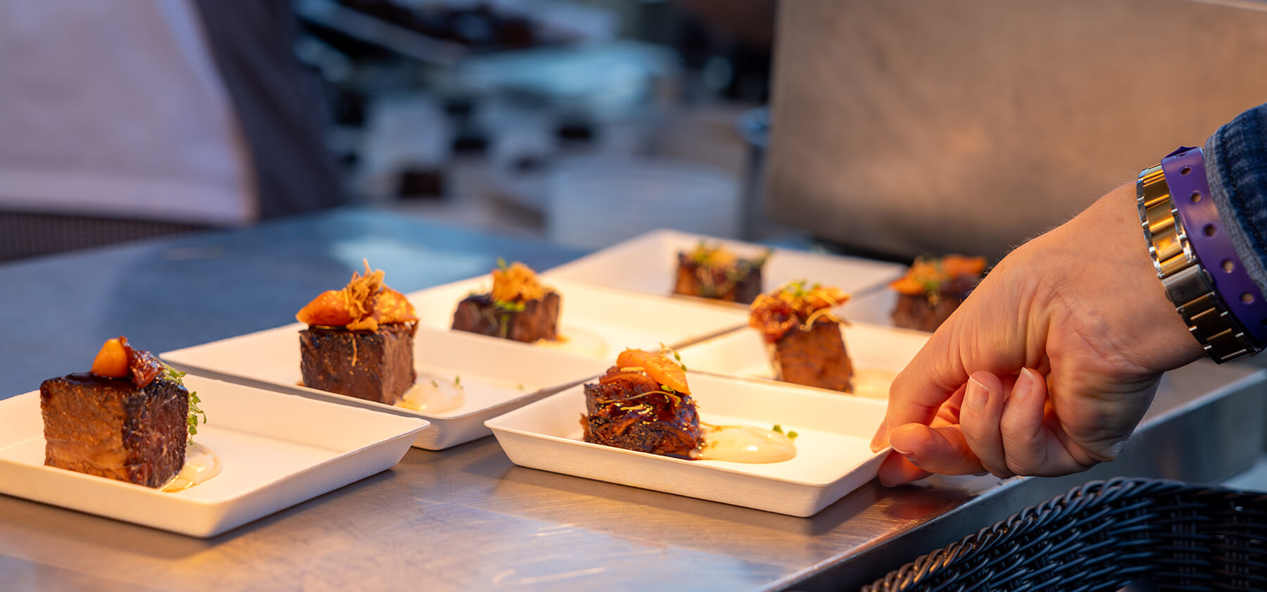 A hand holding a plate of food.